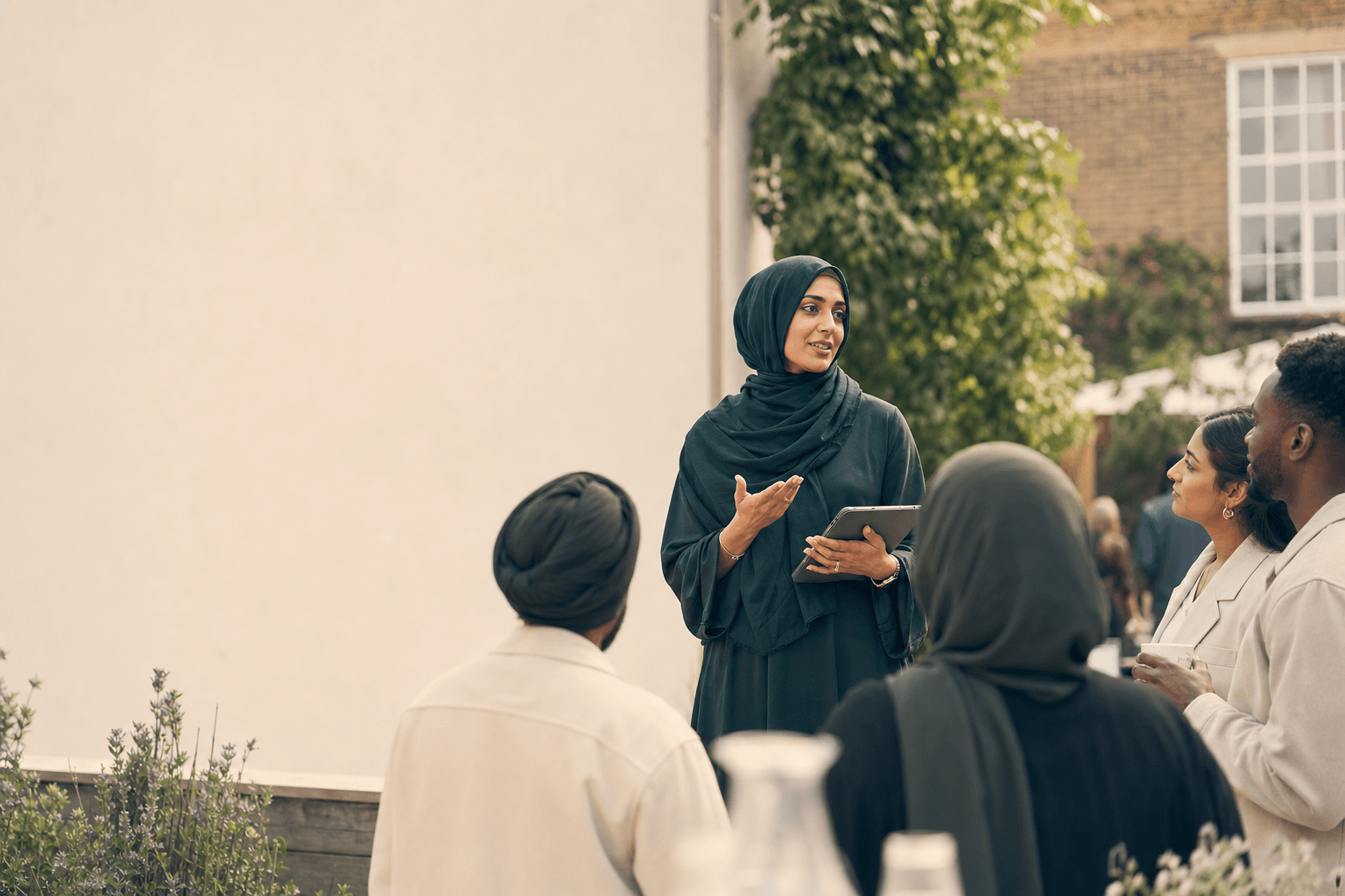 A Muslim organiser speaking with attendees at a community event